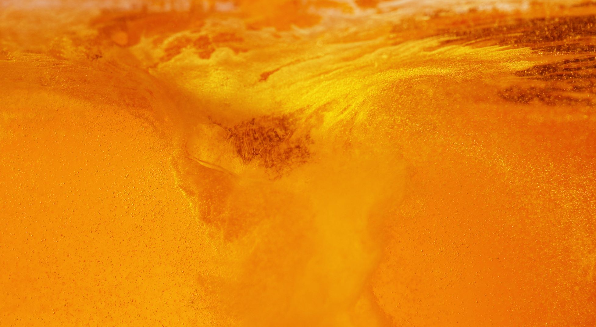 orange liquid closeup with sparkles inside